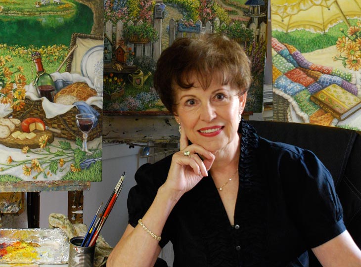 Janet Kruskamp in her studio. Behind her are her original paintings. Own a beautiful  personally enhanced and hand signed giclee of your favorite Janet Kruskamp painting. 