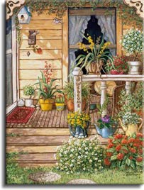 Summer Front Porch, an original oil painting and a giclee , personally enhanced and by the artist Janet Kruskamp showing the front door, narrow window and a deck like porch. Round aggregate paving stones lead up to the three steps of the porch, bordered on the right side with brightly colored white and red flowers. A wicker chair sits behing the white railing of the porch surrounded by pots of bright blooming flowers. Three colorful watering cans serve as planters on the second step up. A carved hanging chain of letters spells out WELCOME on the front rail post.