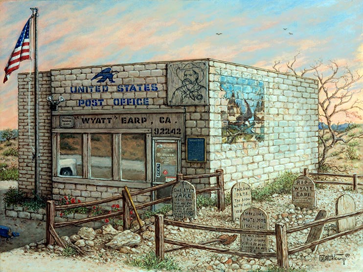 The squat block building of the Post Office in Earp, California, sits in front of the beginning of a sunset, the light blue sky painted with wispy orange clouds. A Boot Hill style graveyard next to the building is fenced off by a split rail fence on the rocky ground. The front window reflect the parking lot and the front of a white truck. The side wall of the post office has a fading outdoor mural in the upper left corner. A drawing of Wyatt Earp is attached to the front of the building next to the official blue sign with the eagle USPS logo. Small scrub bushes dot the landscape around the building.